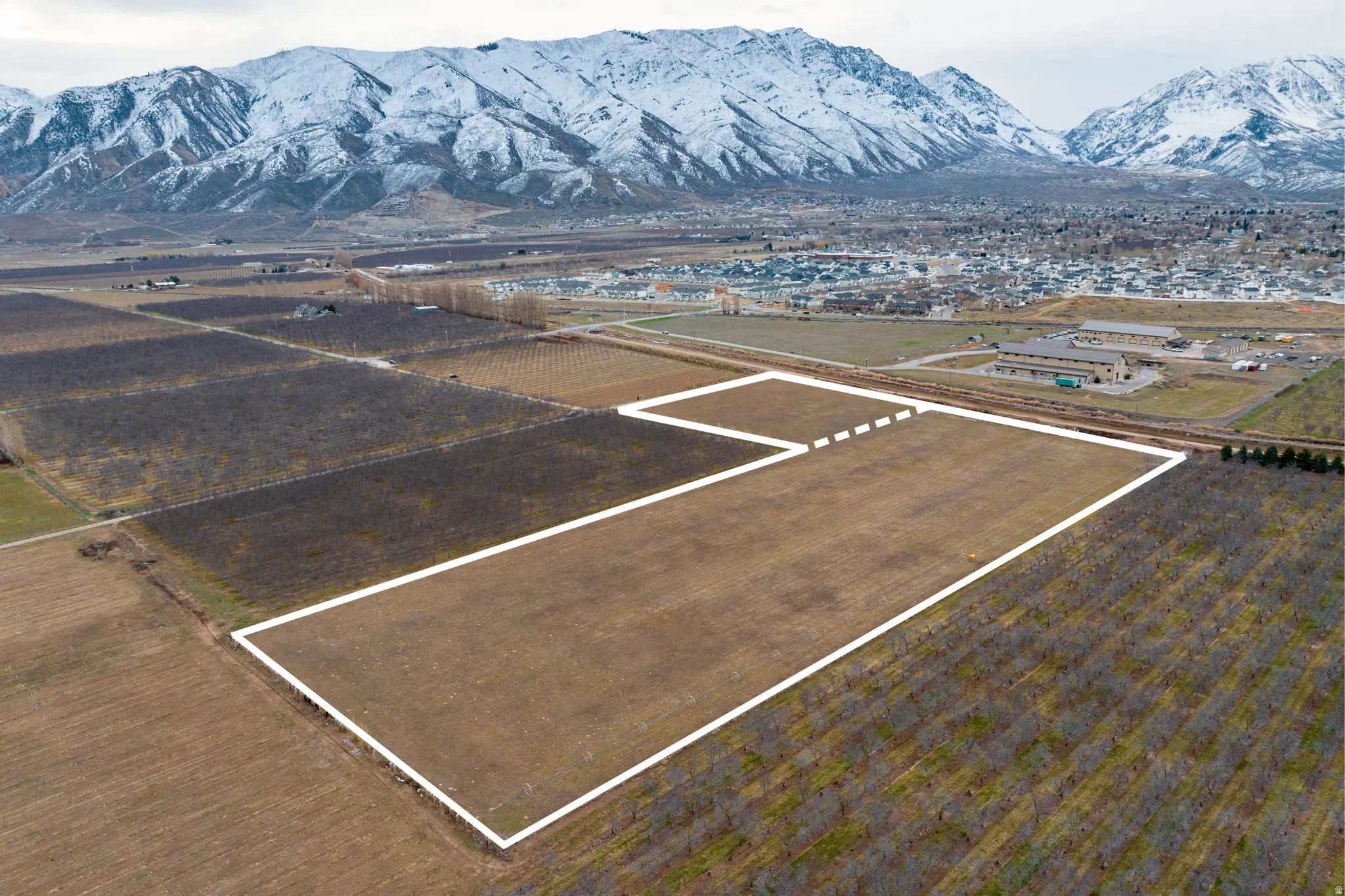 Expansive land parcel with direct road frontage, surrounded by agricultural fields