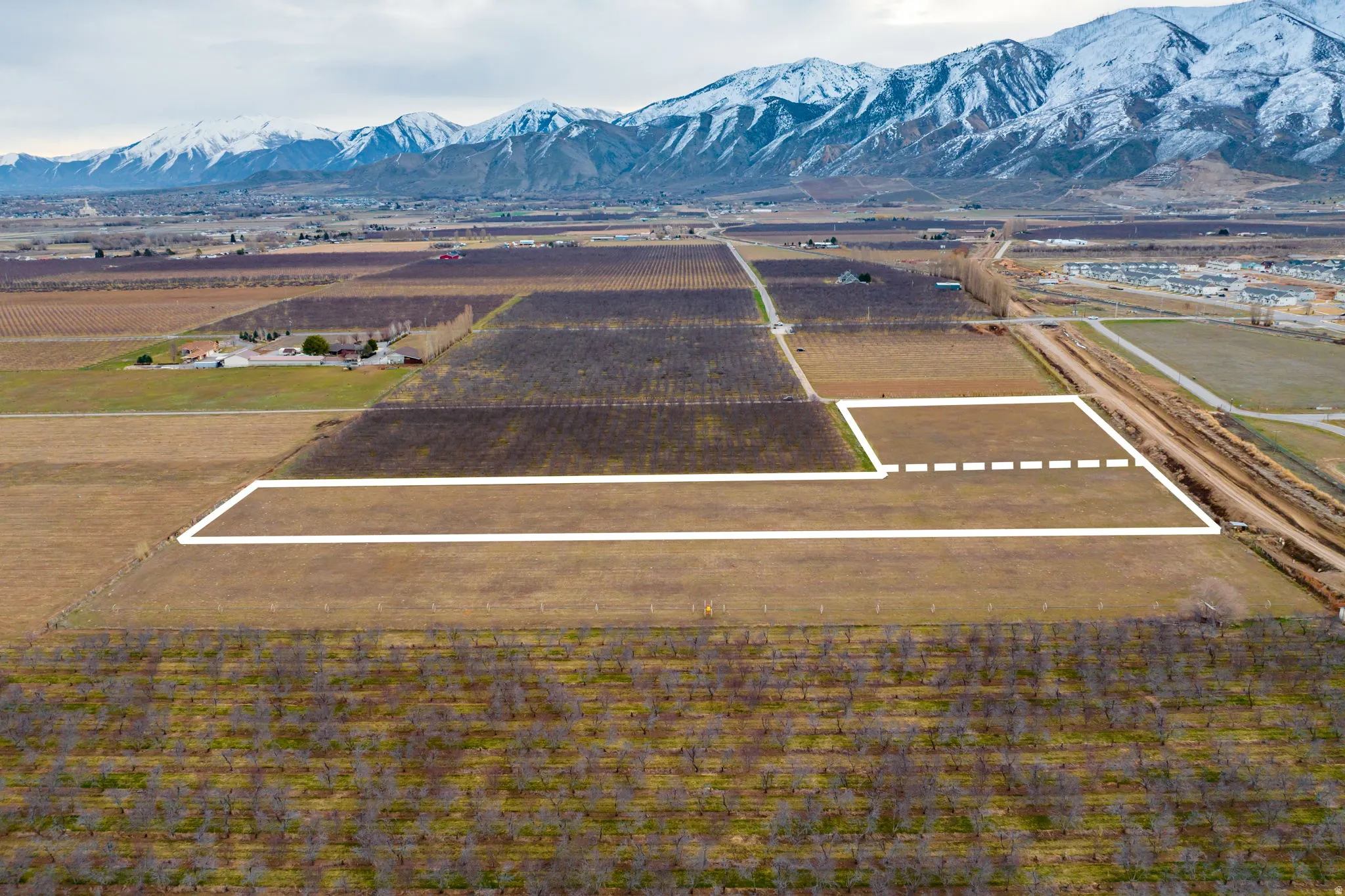 Expansive land parcel outlined in white, featuring clear, level terrain