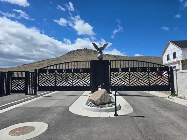 Wrought iron entry gates featuring geometric designs and an eagle sculpture