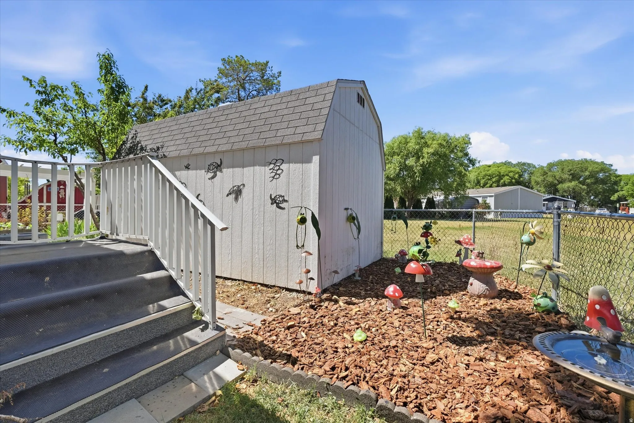 Detached storage shed with gambrel roof and vertical siding