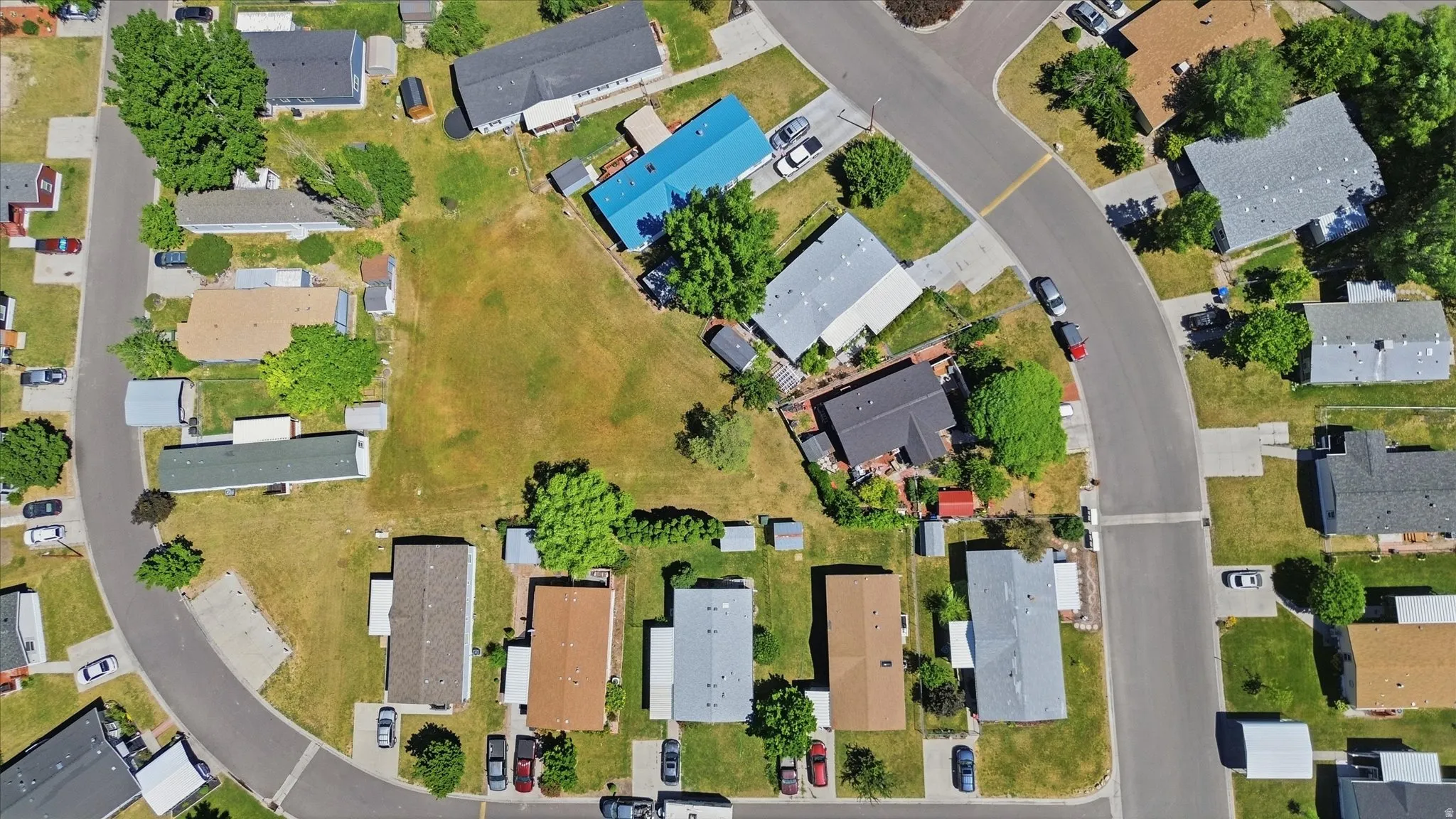 Residential area featuring paved streets and varied rooflines