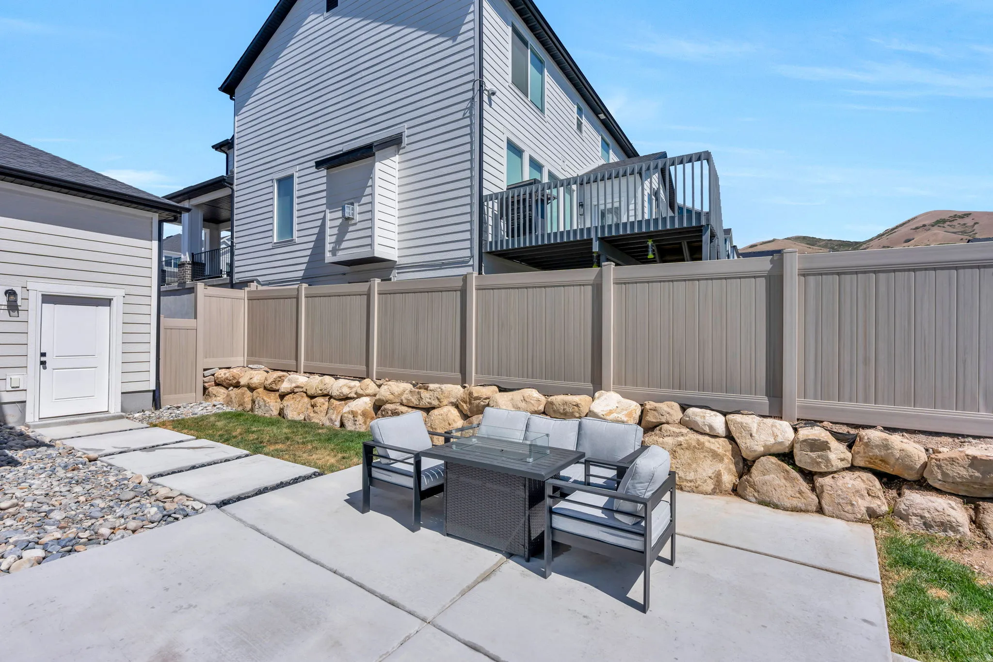 Outdoor patio space featuring concrete paving and decorative stepping stones