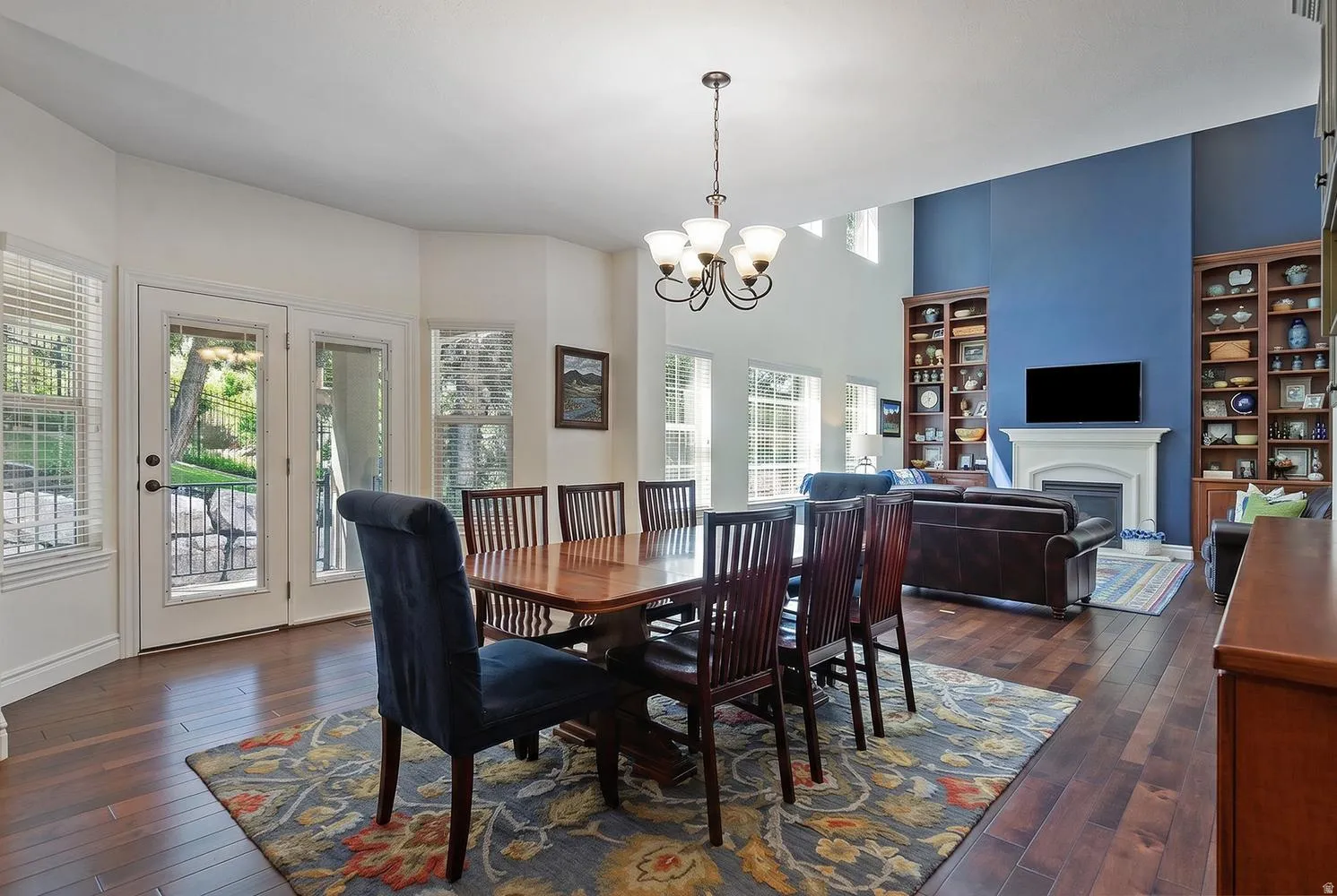 Dining area with wood-finish flooring and a multi-pane glass patio door