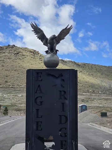Monumental entrance sign featuring an eagle statue atop a sphere