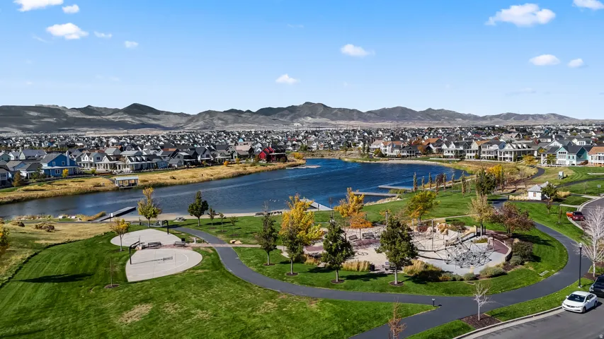Oquirrh Lake featuring walking trails, open green space, and one of Daybreak's signature waterfront amenities.