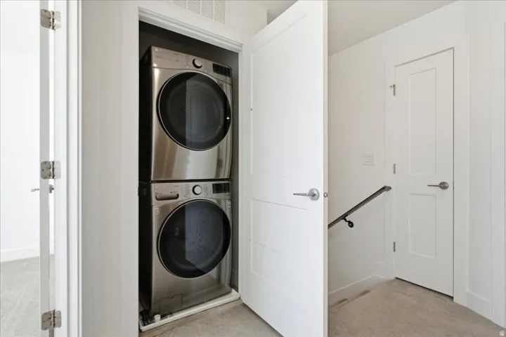 Convenient upper-level laundry with stacked washer and dryer located near all bedrooms.