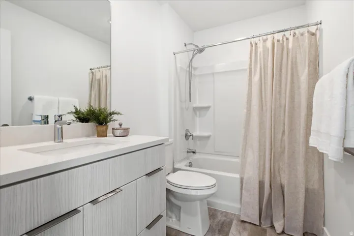 Secondary bathroom with contemporary finishes, quartz vanity, and integrated storage.