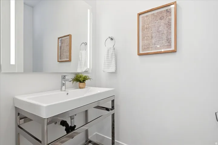 Convenient main-level powder bathroom with contemporary finishes.