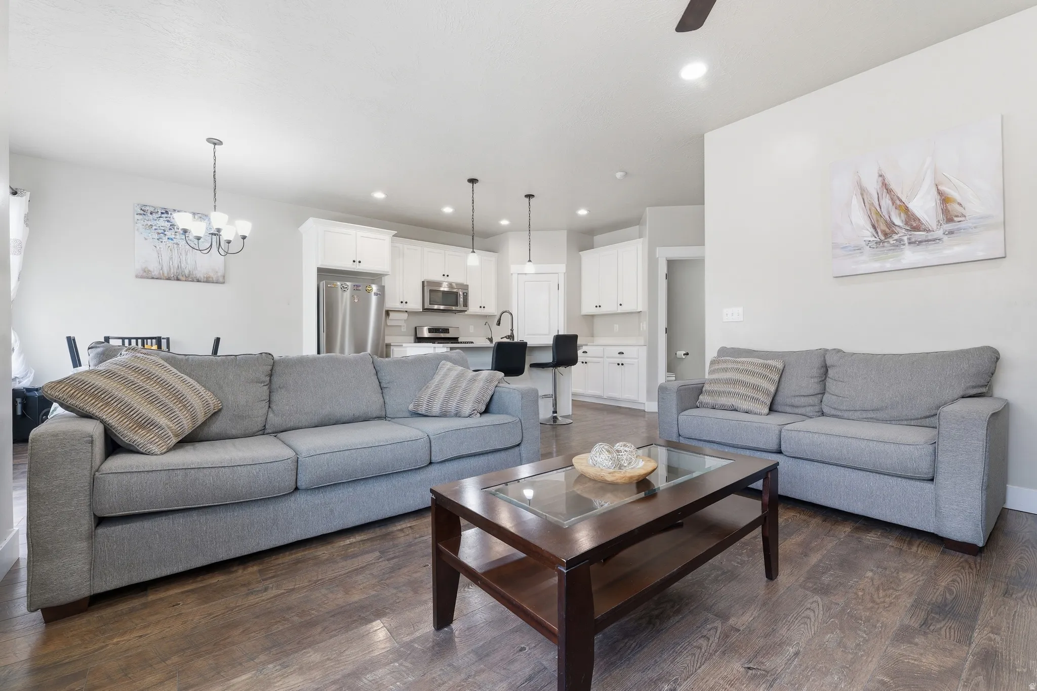 Open-concept living area featuring wood-finish flooring and recessed lighting