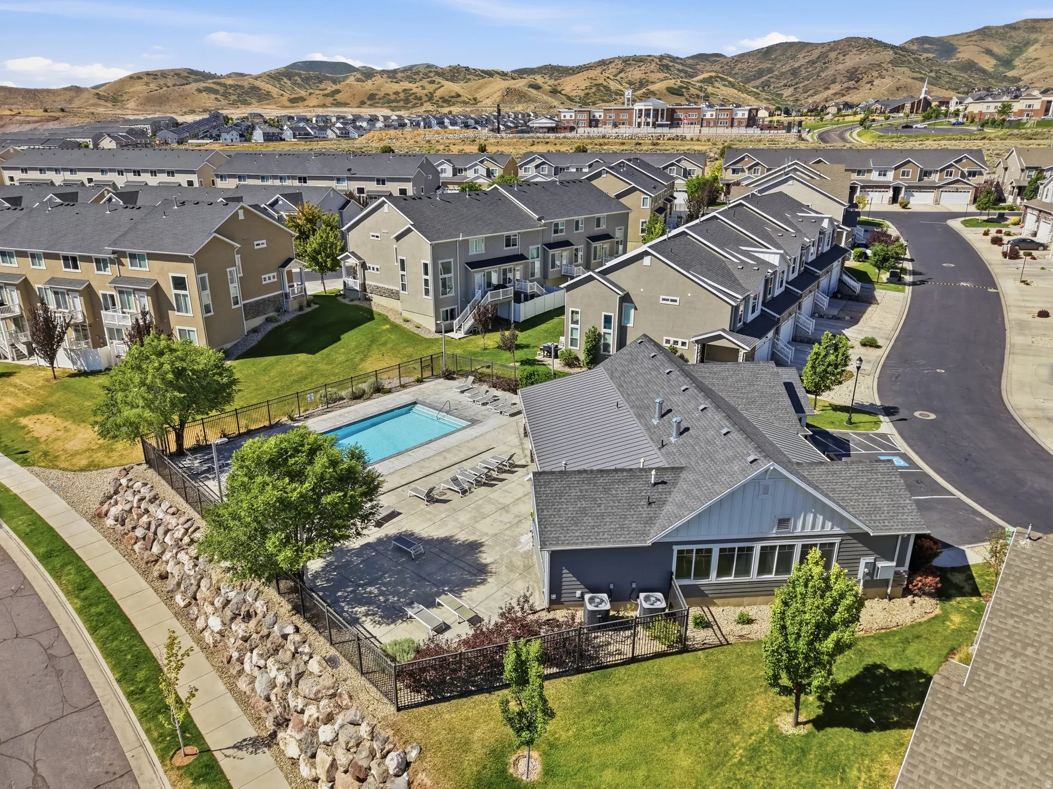 Fenced-in outdoor pool surrounded by a paved deck