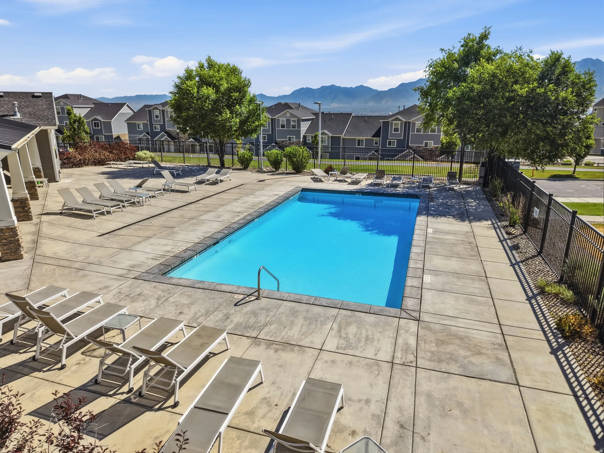 Rectangular swimming pool surrounded by a concrete deck