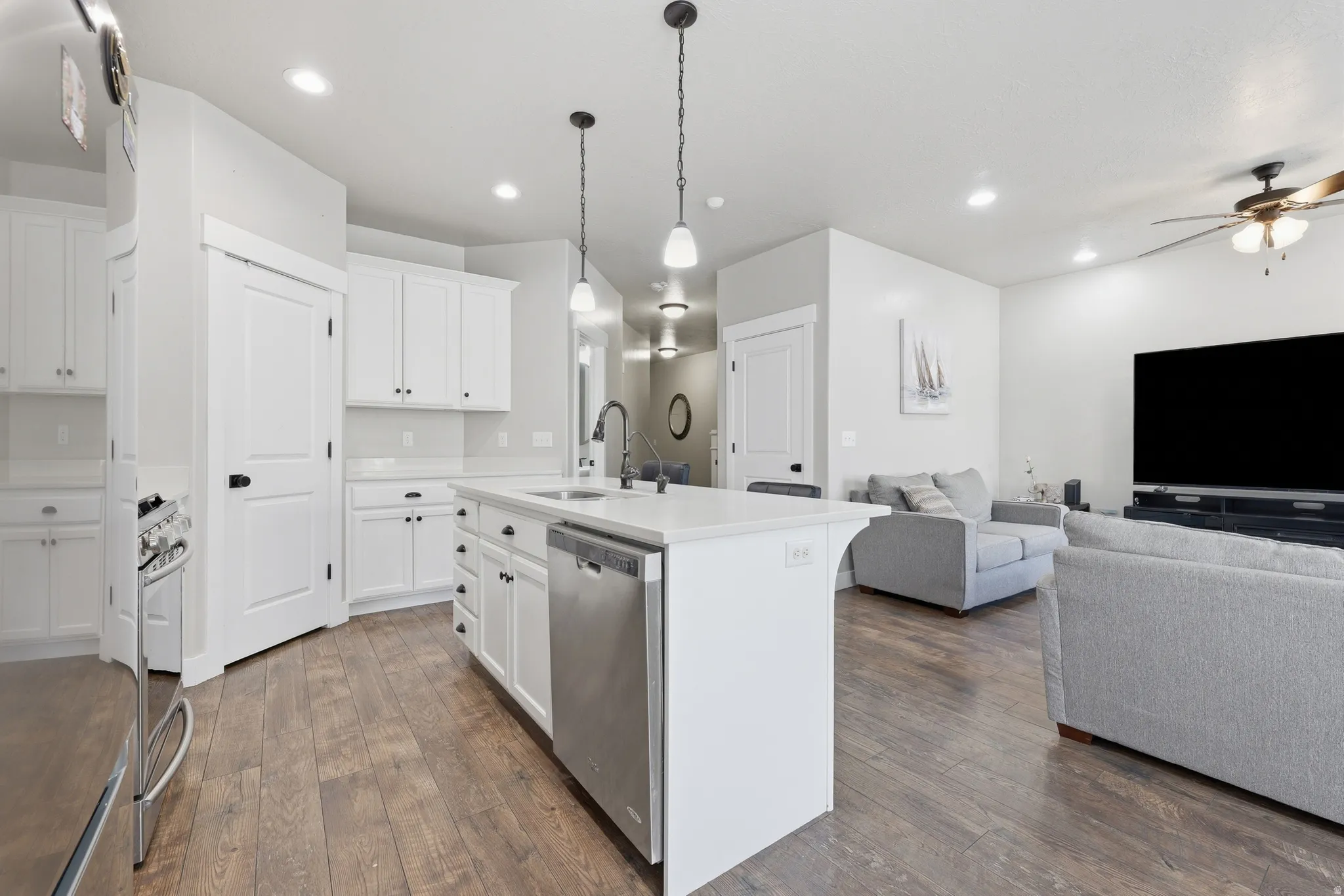 Open-concept kitchen and living area featuring wood-finish flooring
