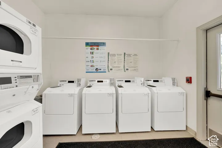 Dedicated laundry facility featuring multiple front-loading washing machines and stacked dryers
