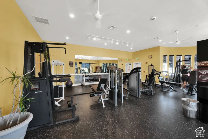 Fitness center featuring multiple exercise machines, weight equipment, rubberized flooring, and recessed lighting