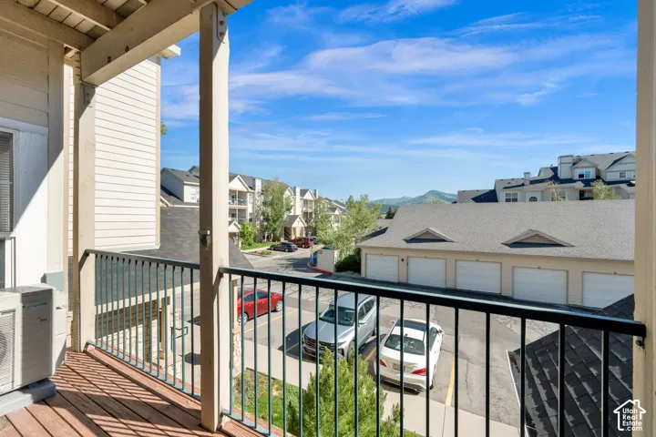Balcony with wood-finish flooring and black metal railing