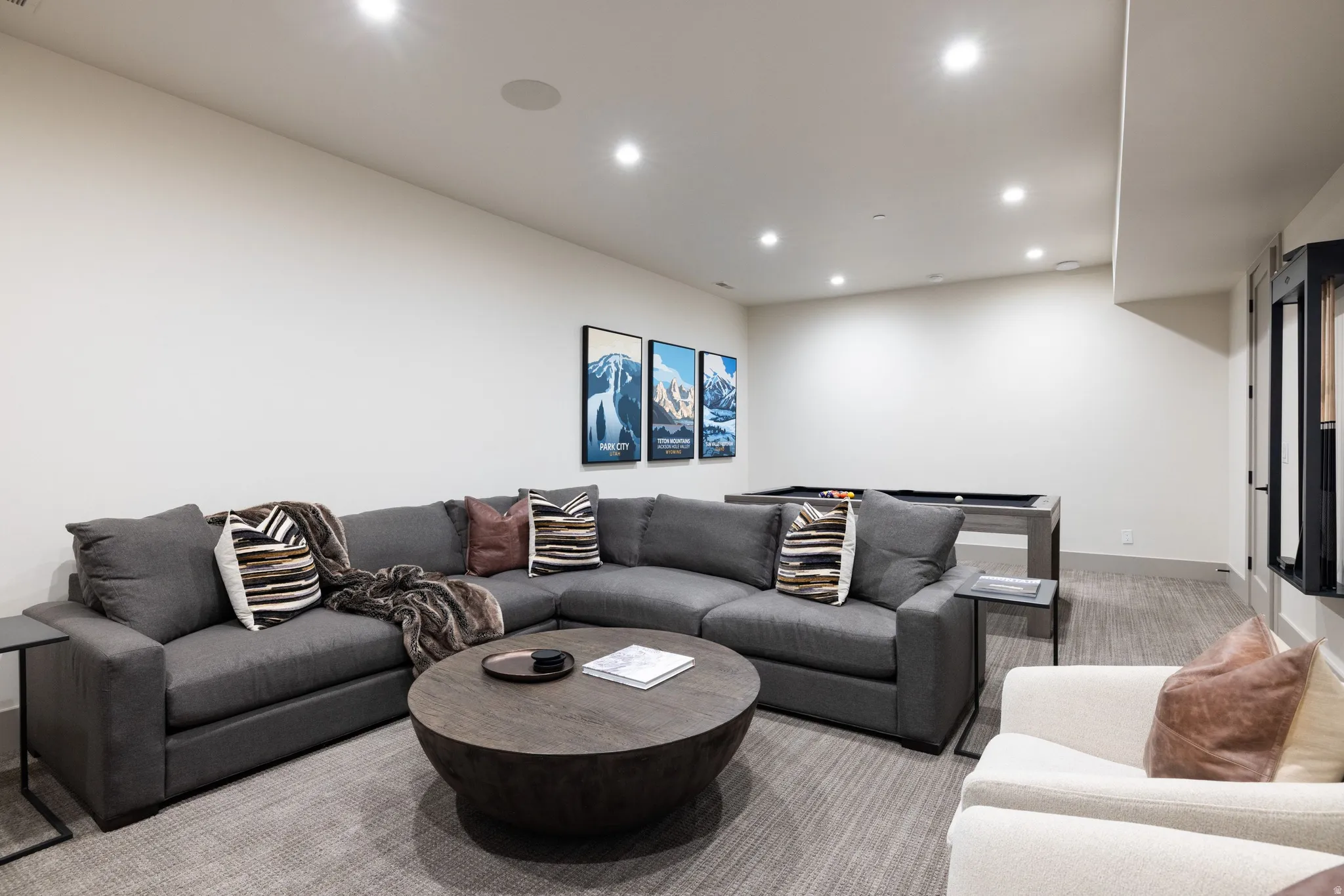Recessed lighting illuminates this expansive space featuring a pool table and integrated ceiling speaker