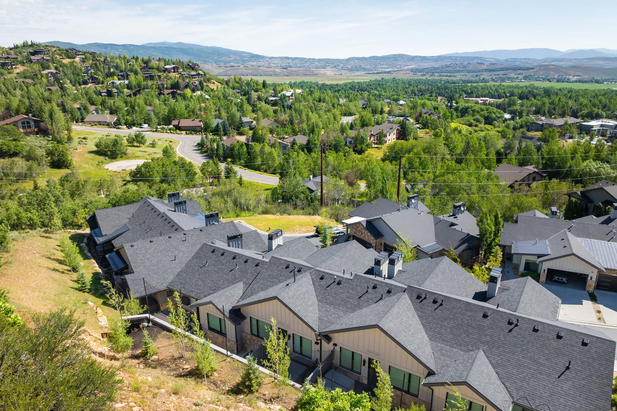 Contemporary residences featuring multi-pitched roofs and exterior siding