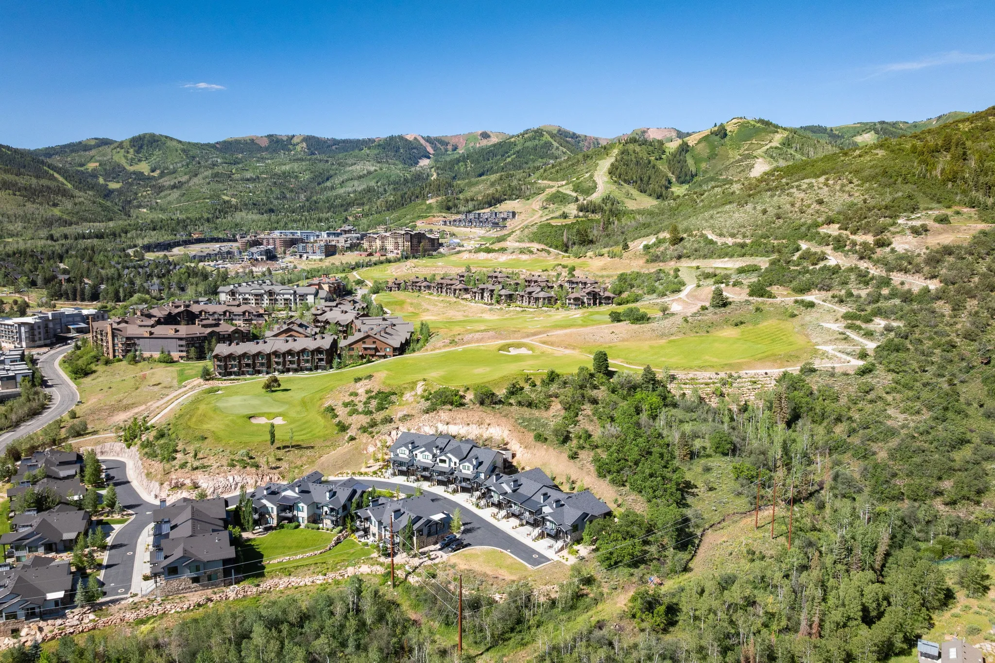Aerial perspective showcasing a residential community nestled within a mountainous landscape