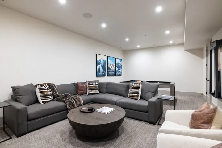 Recessed lighting illuminates this expansive space featuring a pool table and integrated ceiling speaker