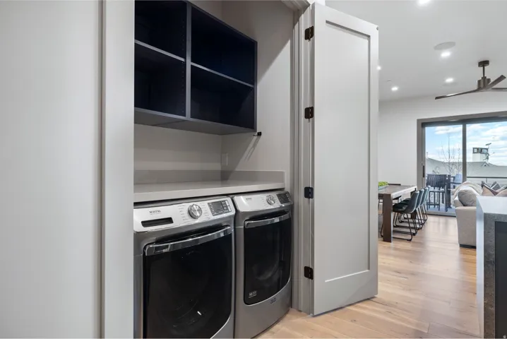 Dedicated laundry area featuring a countertop surface and built-in shelving