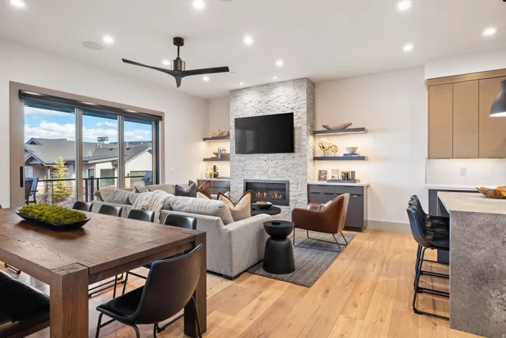 Open-concept living area featuring wood-finish flooring, a contemporary ceiling fan, and recessed lighting