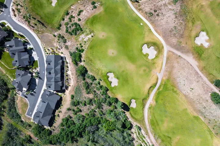 Aerial perspective showcasing residential properties bordering a golf course