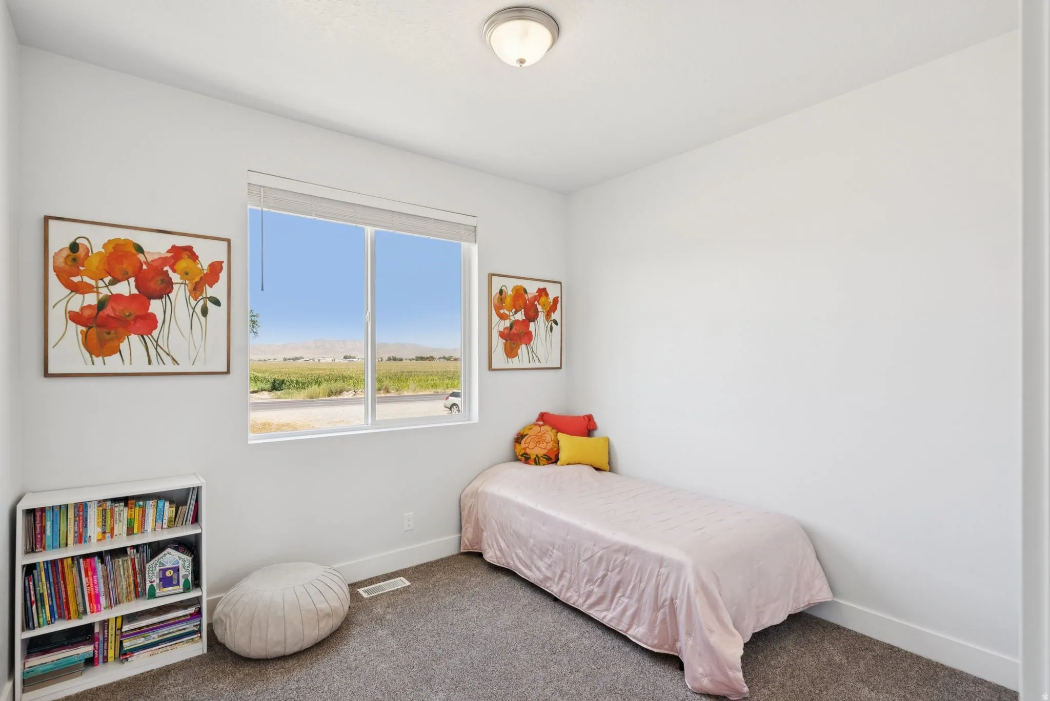 Bright interior space featuring a large window with distant mountain scenery