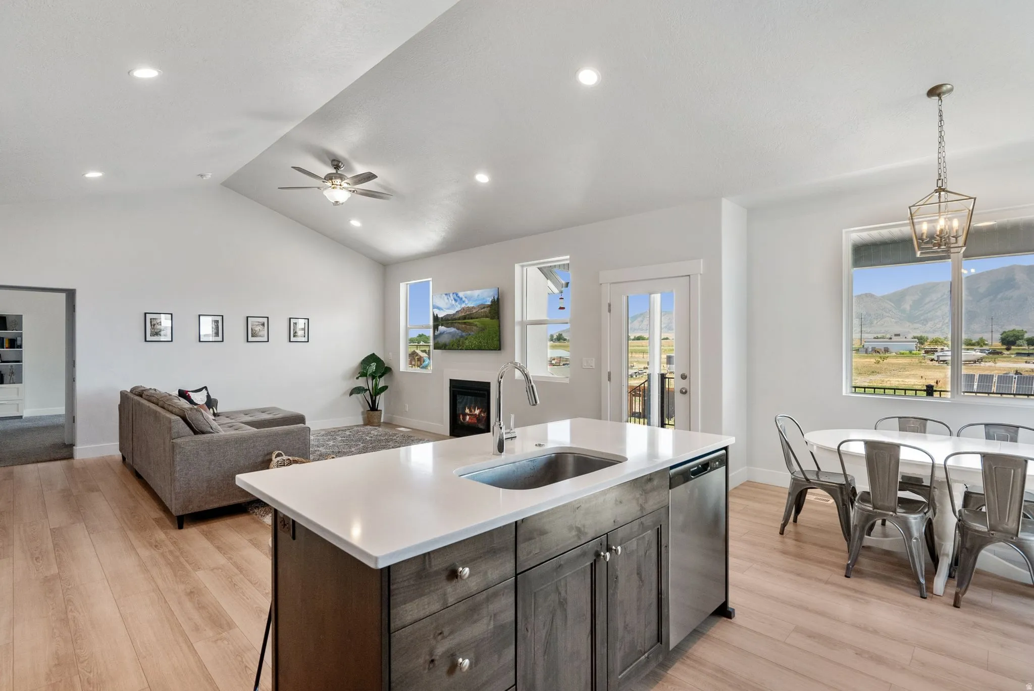Open-concept living space with vaulted ceilings and wood-finish flooring