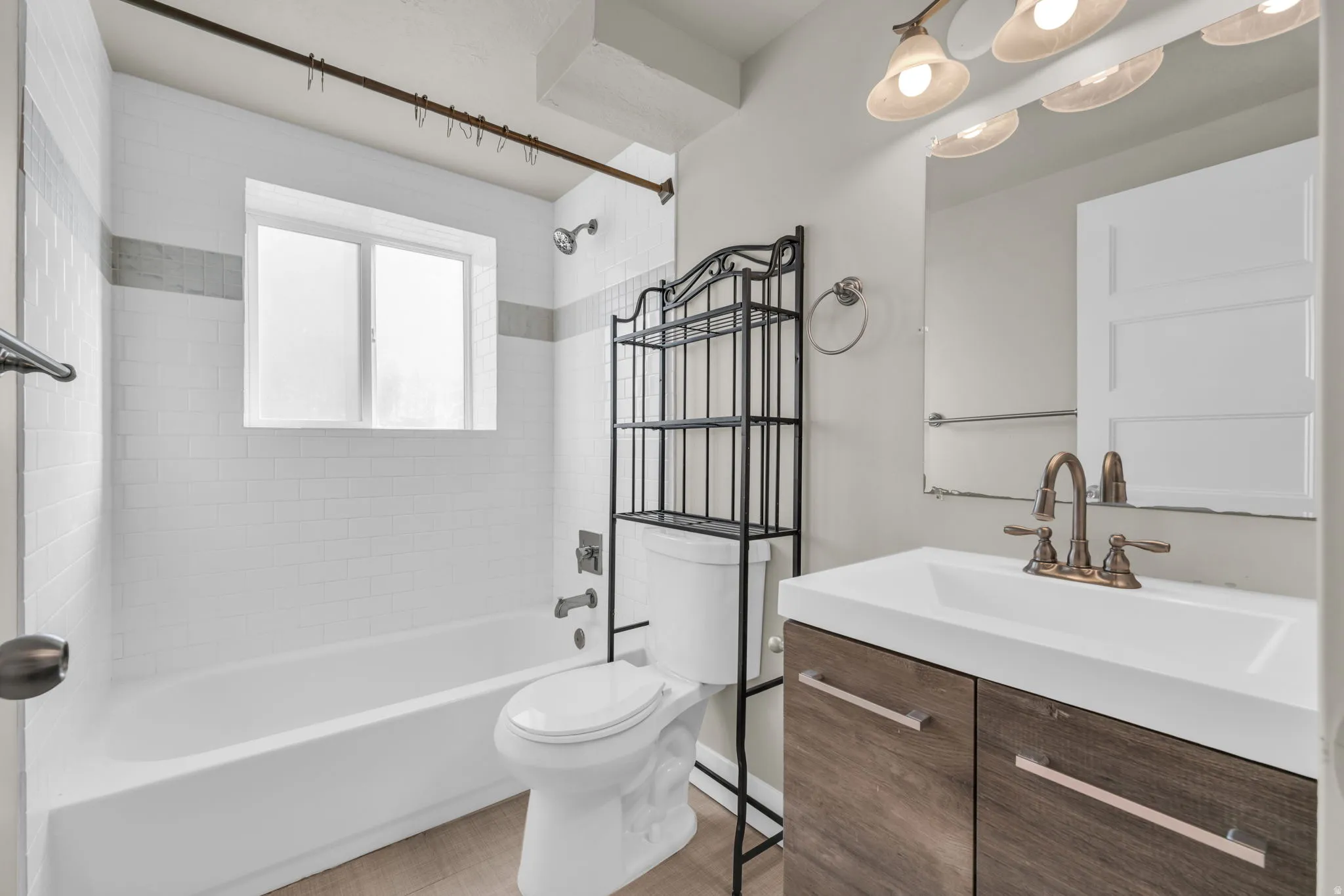 White subway tile tub surround with a light gray accent band