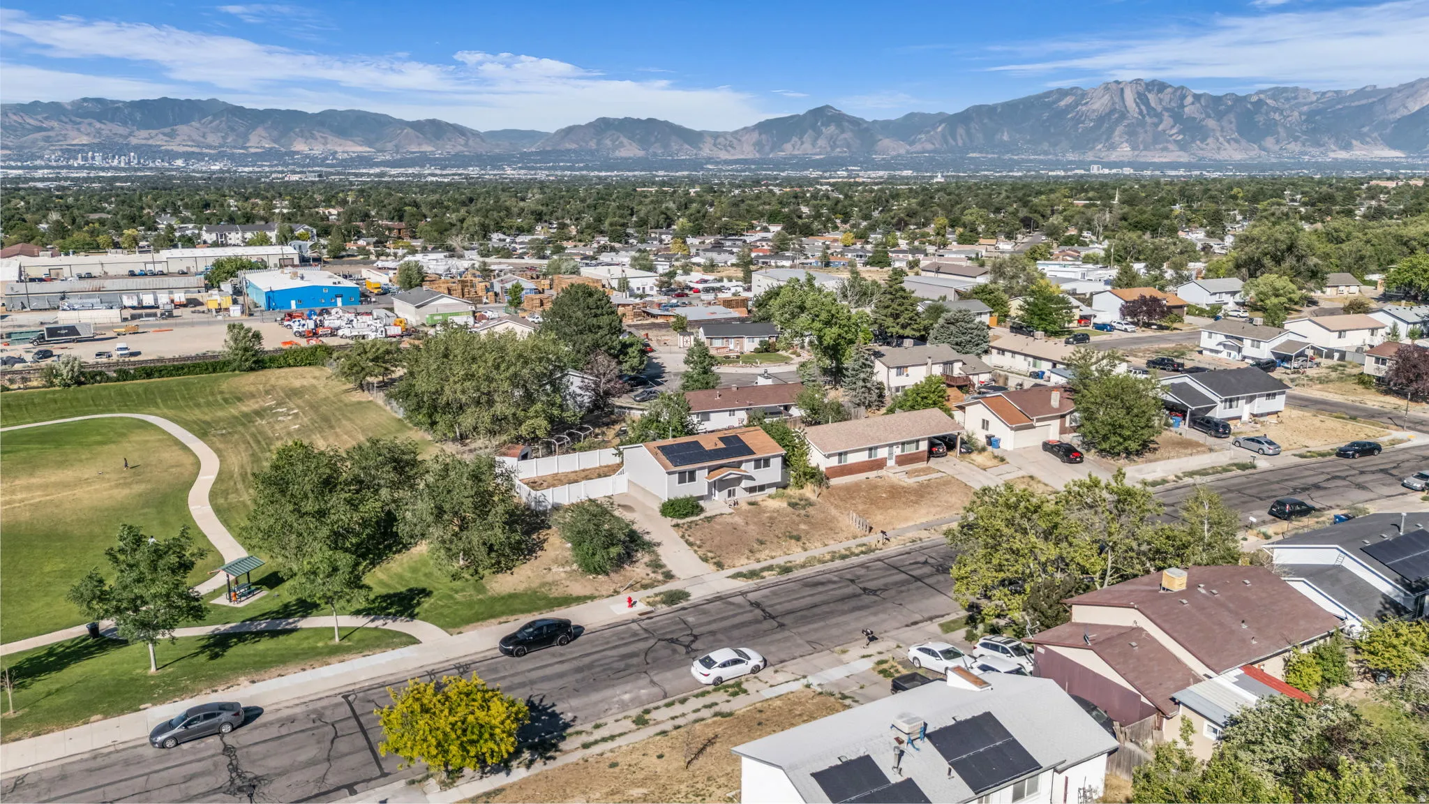 Residential neighborhood featuring single-story and multi-level homes with various roof styles and materials, including solar panels on some properties