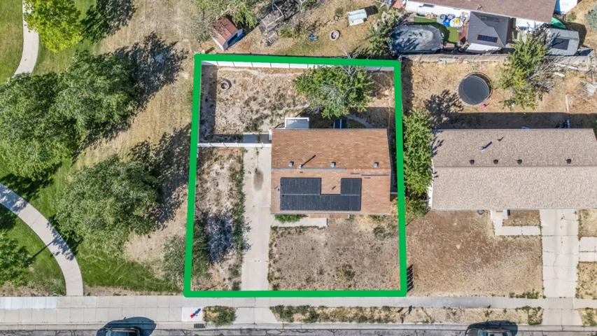 Aerial property overview featuring a substantial land parcel, established fencing, and mature trees