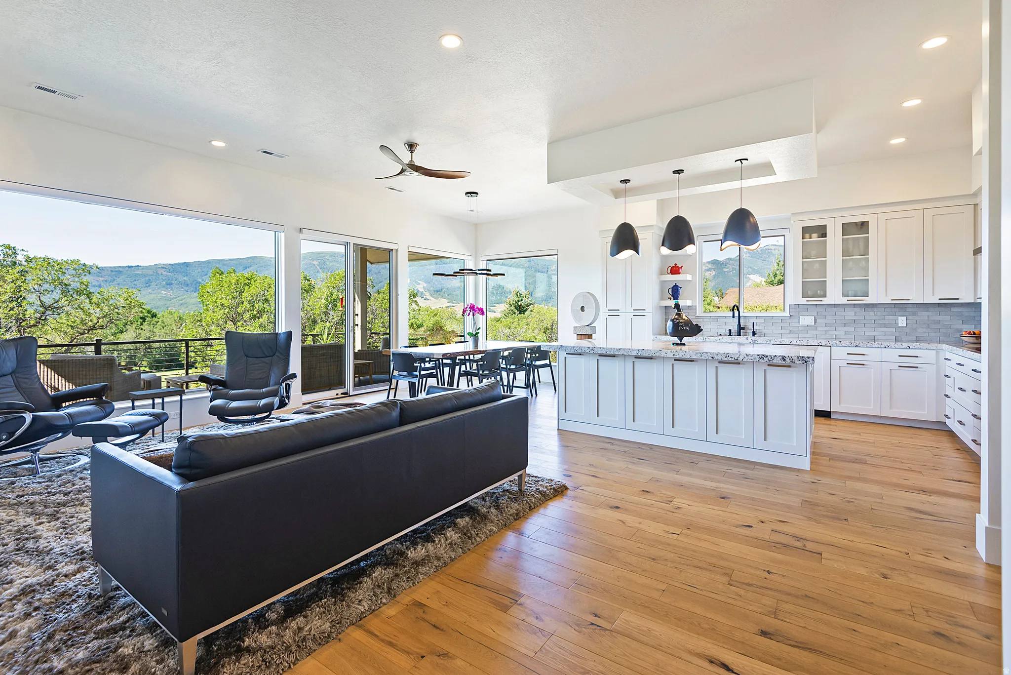 Expansive open-concept living space with wood-finish flooring