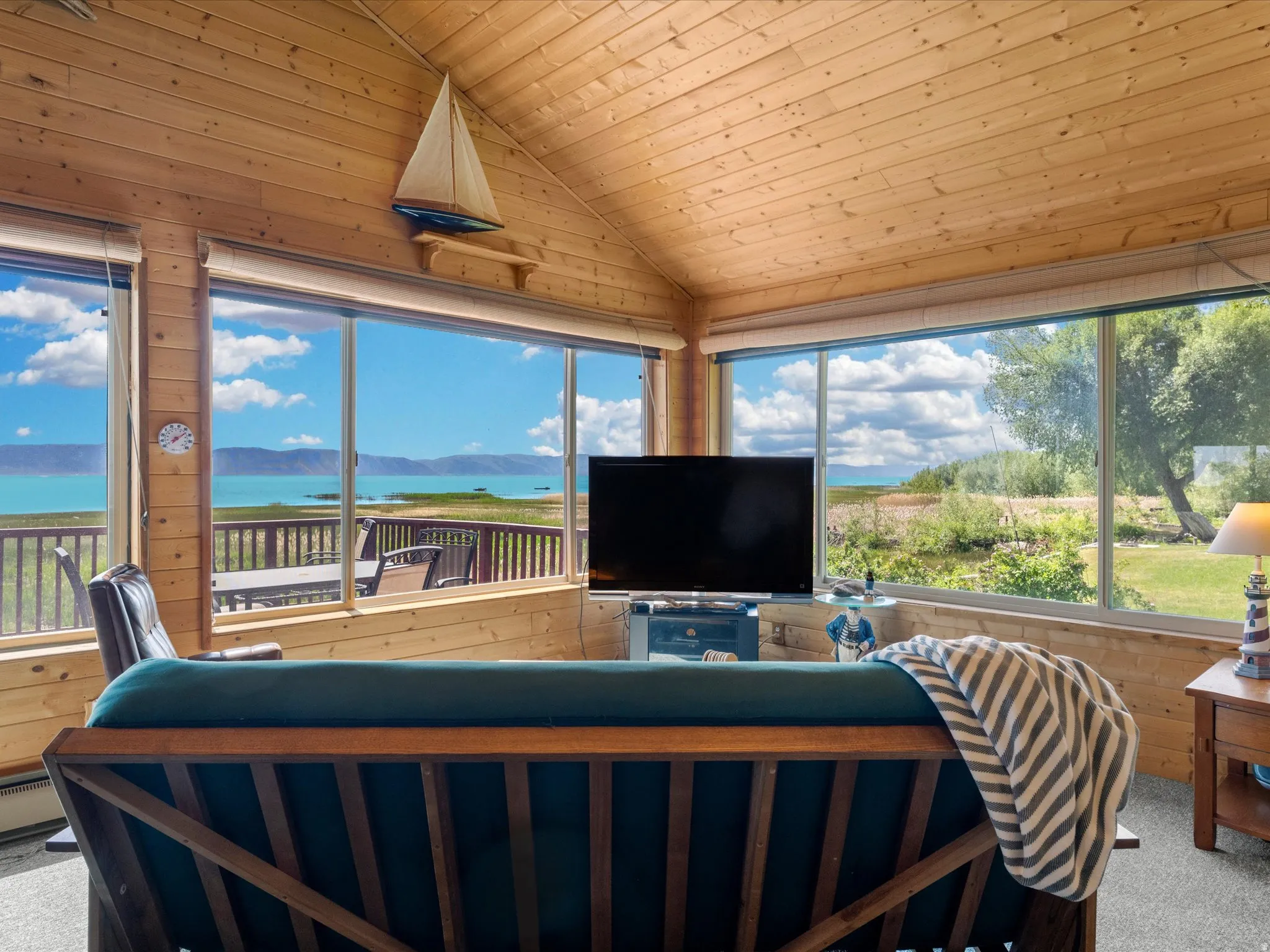 Expansive windows showcasing a waterfront and mountain backdrop