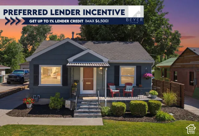 Exterior featuring dark-toned siding, decorative shutters, a metal-roofed front porch awning, and a stone-clad porch foundation with matching steps