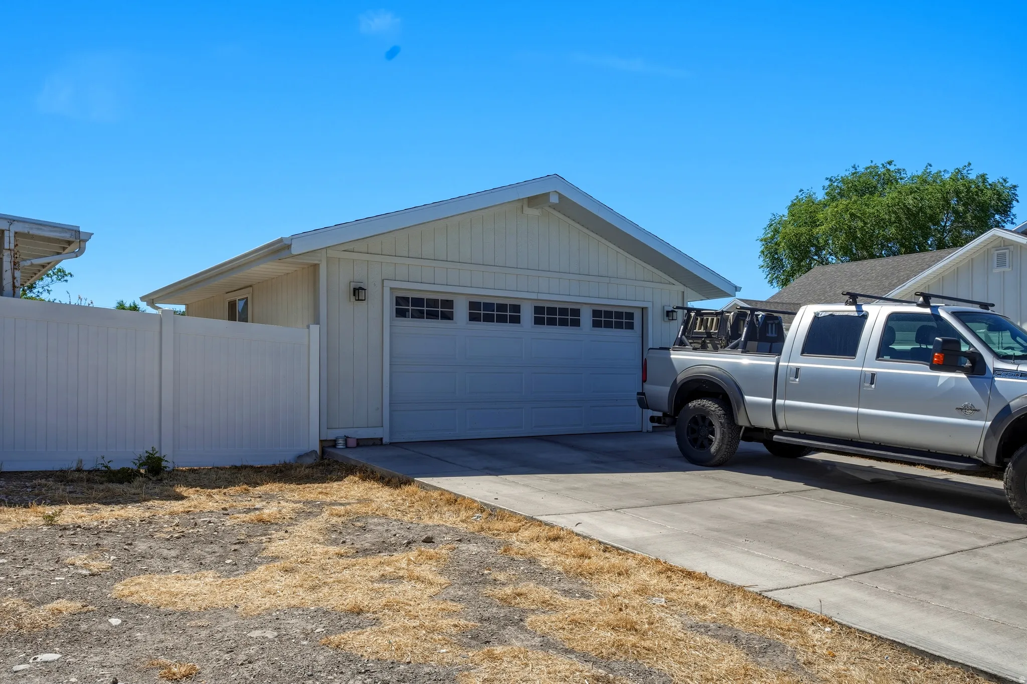 Attached two-car garage featuring a panel-style door with upper window inserts