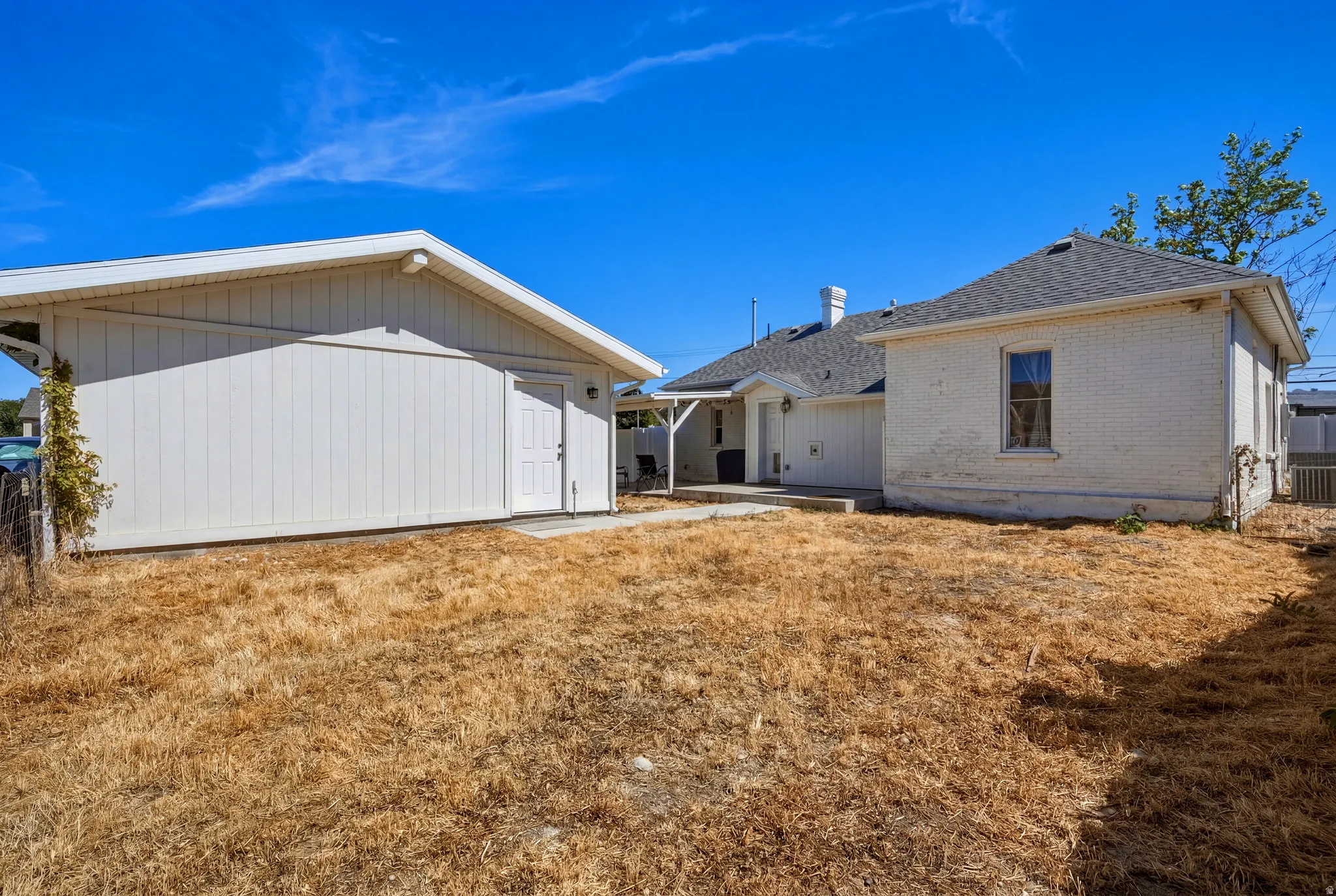Detached garage with horizontal siding and a side-entry door