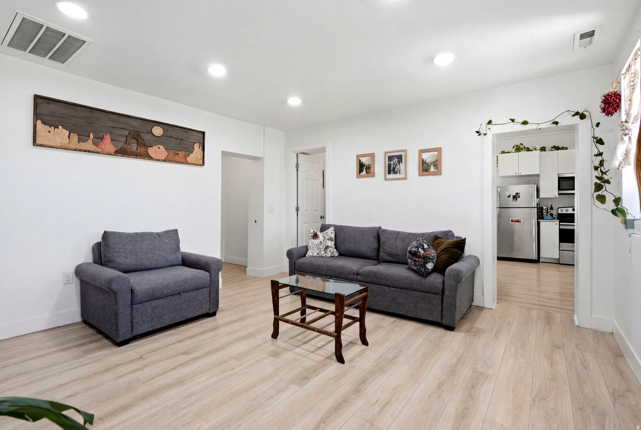Bright interior space featuring light wood-finish flooring and recessed ceiling lighting