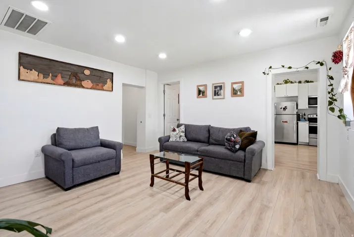 Bright interior space featuring light wood-finish flooring and recessed ceiling lighting
