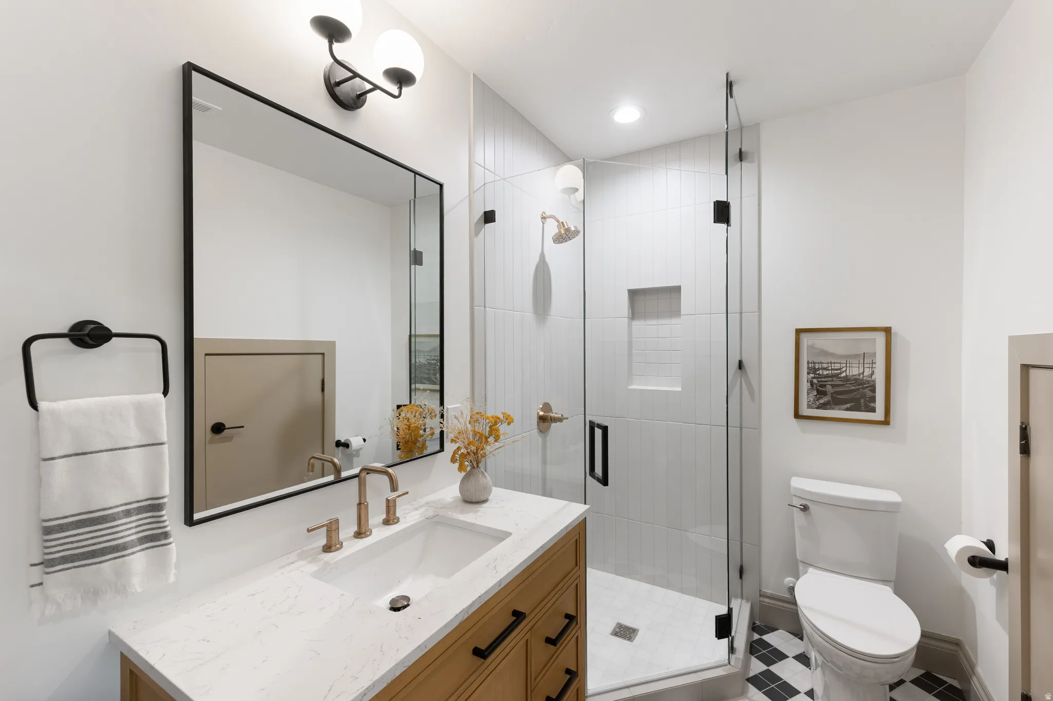 Bathroom featuring a single vanity with light wood-finish cabinetry and a white countertop