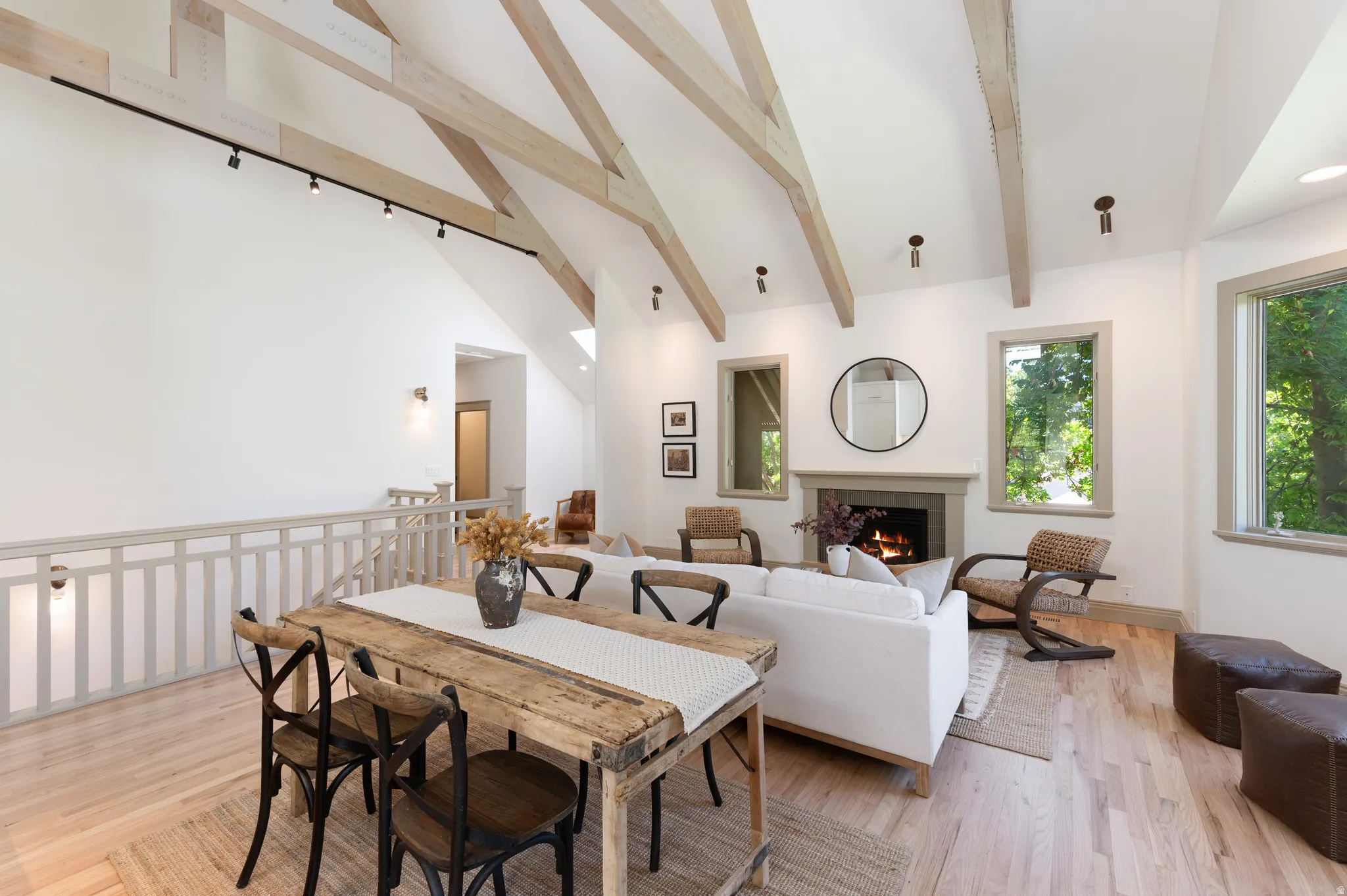 Vaulted ceilings with exposed wood beams define this open-concept living space