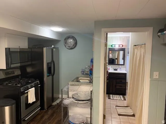 Kitchen area featuring stainless steel appliances and overhead cabinetry