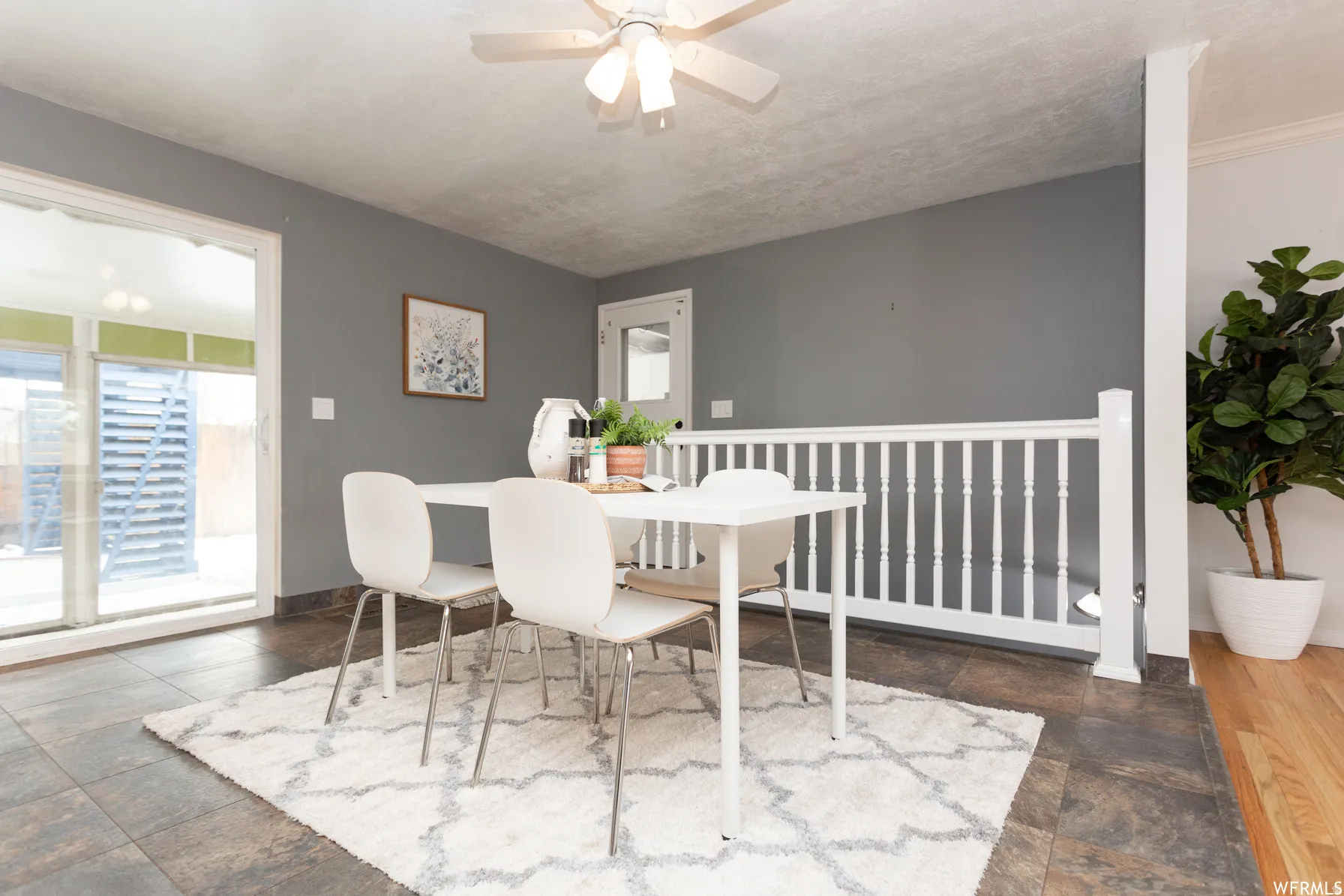 Dining area with tile flooring and a white railing