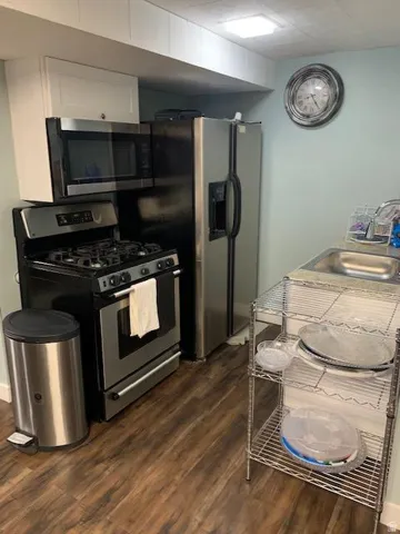Compact kitchen space featuring wood-finish flooring