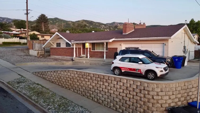 Ranch-style residence featuring a brick facade with siding accents and an attached two-car garage