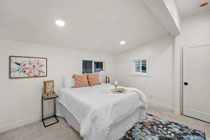 Bright bedroom featuring recessed lighting and wall-to-wall carpeting