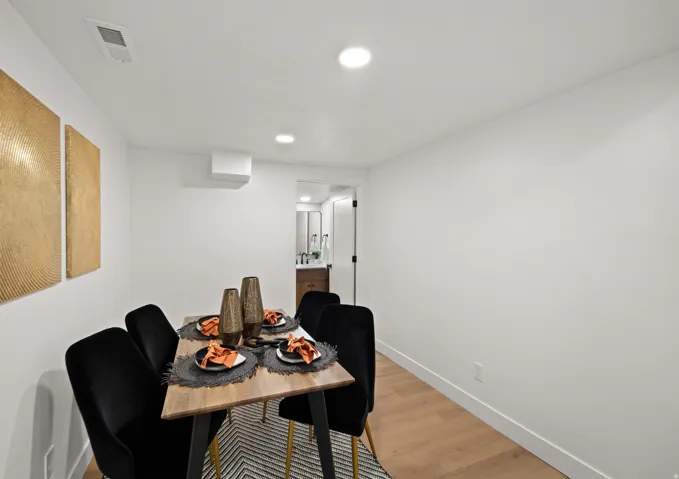 Dining area featuring recessed lighting, a ceiling-mounted climate control unit, and wood-finish flooring
