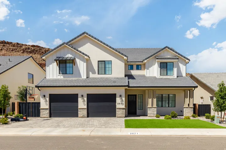 Contemporary two-story residence featuring a tile roof, stucco and board-and-batten siding, and an attached two-car garage