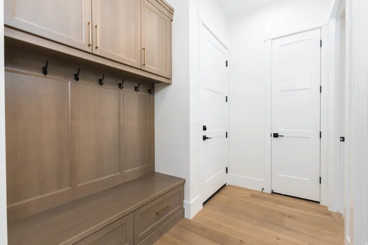 Built-in wood-finish cabinetry, integrated bench seating, and wood-finish flooring