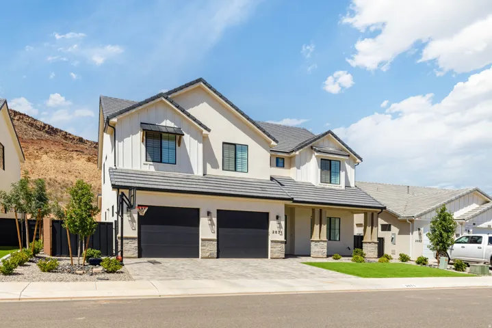 Contemporary two-story exterior with a two-car garage, stone accents, and a covered entry