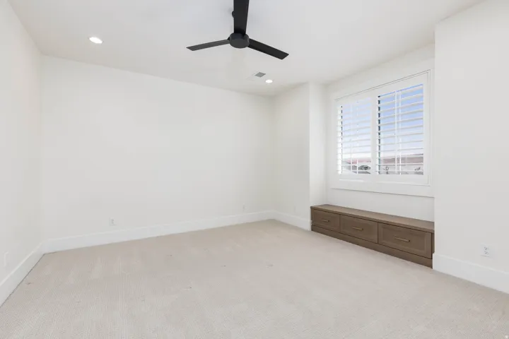 Recessed lighting and a matte black ceiling fan